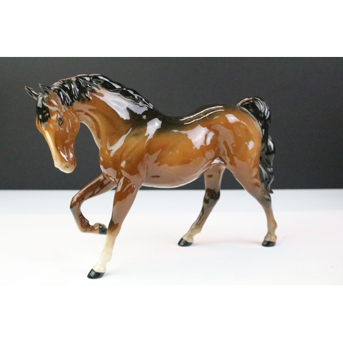 27 - Collection of seven Beswick porcelain horses / ponies to include six brown gloss examples and a matt... 