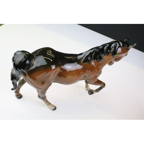 27 - Collection of seven Beswick porcelain horses / ponies to include six brown gloss examples and a matt... 