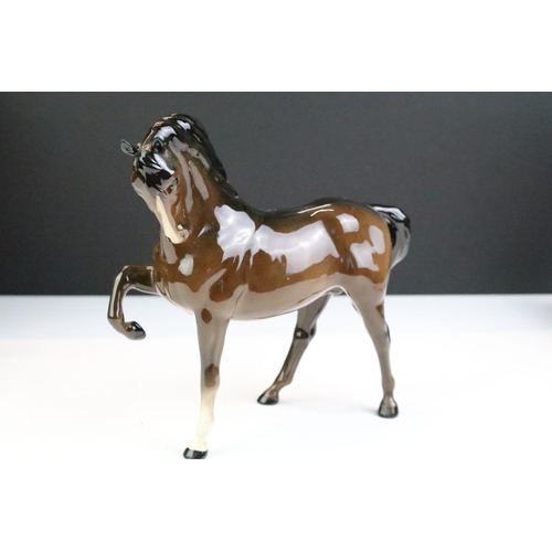 27 - Collection of seven Beswick porcelain horses / ponies to include six brown gloss examples and a matt... 