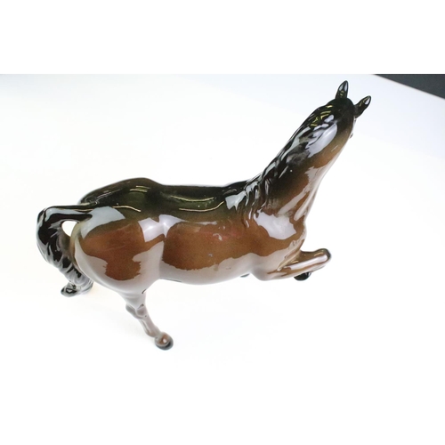 27 - Collection of seven Beswick porcelain horses / ponies to include six brown gloss examples and a matt... 