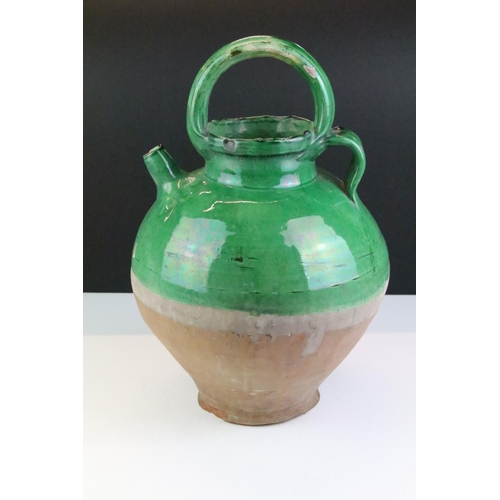 31 - Large pottery green glazed wine ewer, approx 38cm tall