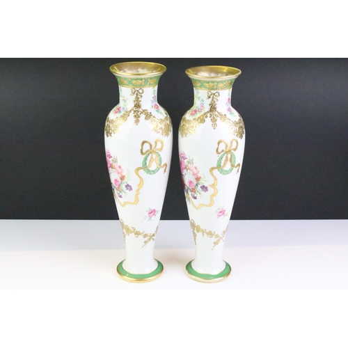 32 - Pair of late 19th / early 20th century porcelain vases of elongated baluster form, with hand painted... 