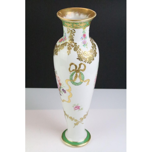 32 - Pair of late 19th / early 20th century porcelain vases of elongated baluster form, with hand painted... 