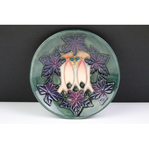 72 - Two Moorcroft pottery pin dishes to include a Cluny pattern dish and an Anemone pattern pin dish on ... 