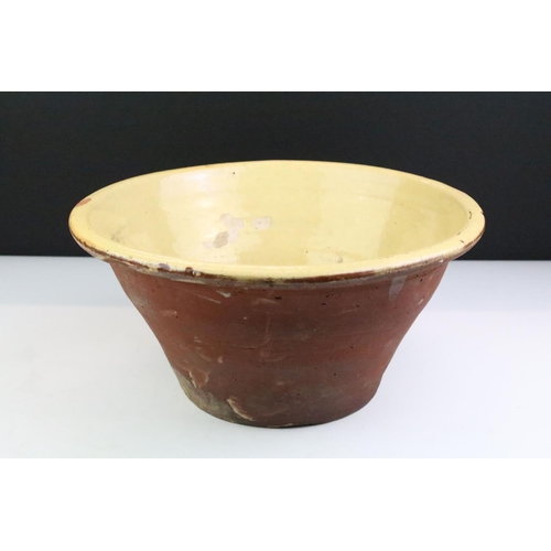 63 - 19th century Terracotta Dairy Bowl with cream glazed interior, 34cm diameter