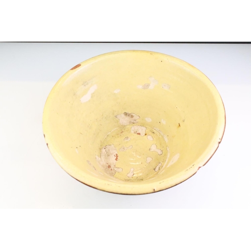 63 - 19th century Terracotta Dairy Bowl with cream glazed interior, 34cm diameter