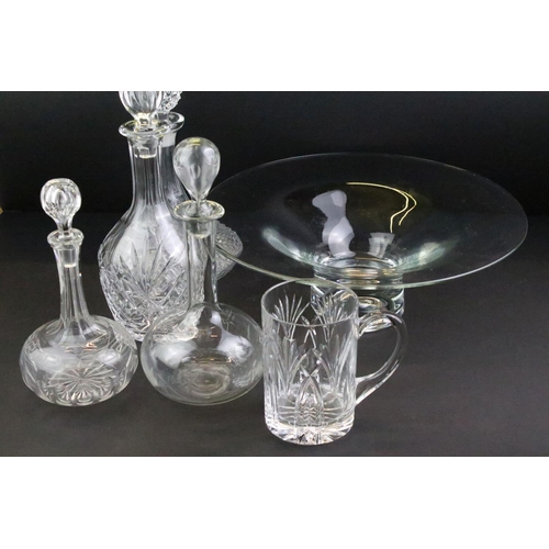 65 - Collection of cut glass to include four decanters with stoppers, a large footed bowl and a cut glass... 