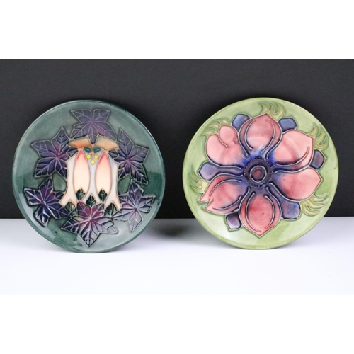 72 - Two Moorcroft pottery pin dishes to include a Cluny pattern dish and an Anemone pattern pin dish on ... 