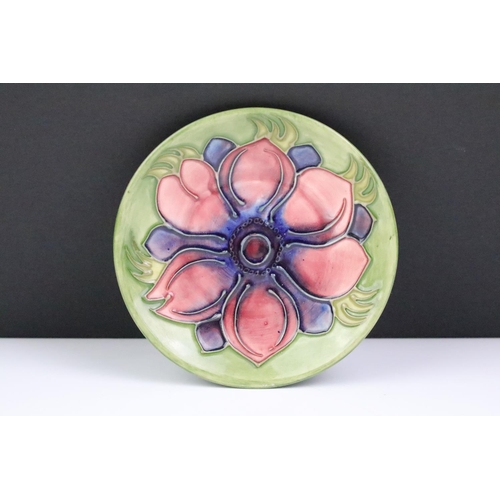 72 - Two Moorcroft pottery pin dishes to include a Cluny pattern dish and an Anemone pattern pin dish on ... 