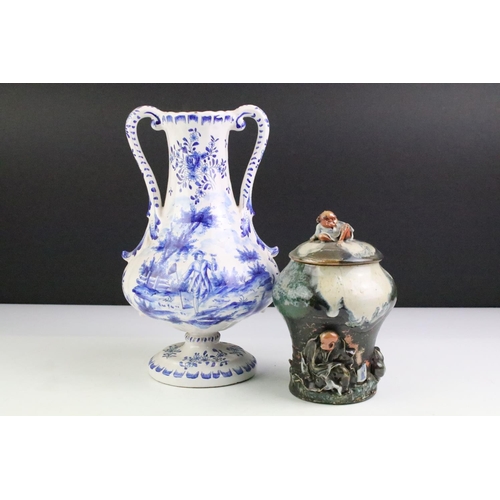 106 - Delft blue and white tin glazed twin handled vase having hand painted detailing featuring a butterfl... 