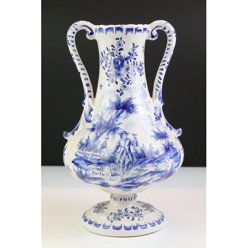 106 - Delft blue and white tin glazed twin handled vase having hand painted detailing featuring a butterfl... 