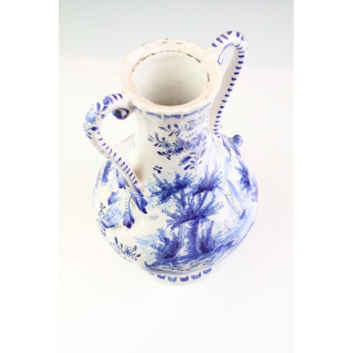 106 - Delft blue and white tin glazed twin handled vase having hand painted detailing featuring a butterfl... 