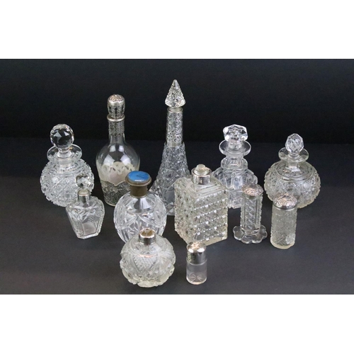 110 - Collection of 12 cut glass perfume bottles & jars to include silver collared & silver lidded example... 