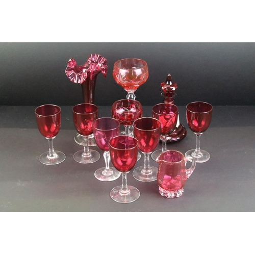 114 - Collection of cranberry glassware, 19th century onwards, to include a set of seven drinking glasses,... 