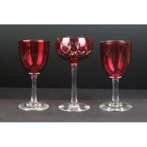 114 - Collection of cranberry glassware, 19th century onwards, to include a set of seven drinking glasses,... 