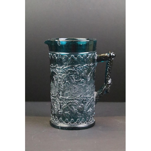 98 - 19th century Kingfisher blue pressed glass jug with leaf & berry detail, approx 16cm tall