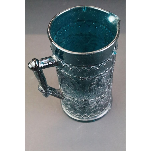 98 - 19th century Kingfisher blue pressed glass jug with leaf & berry detail, approx 16cm tall