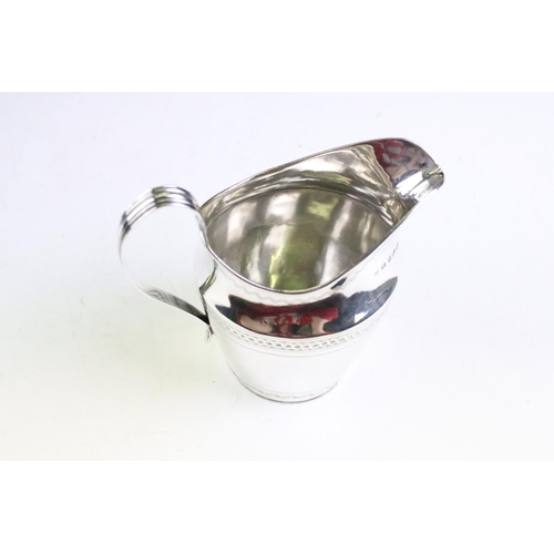 138 - George III silver milk / cream jug with bright cut banding decoration and high loop reeded handle, h... 