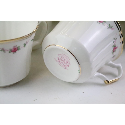 144 - Sandon Heathcote china tea service having a white ground with pink florals and a gilt rim, group of ... 