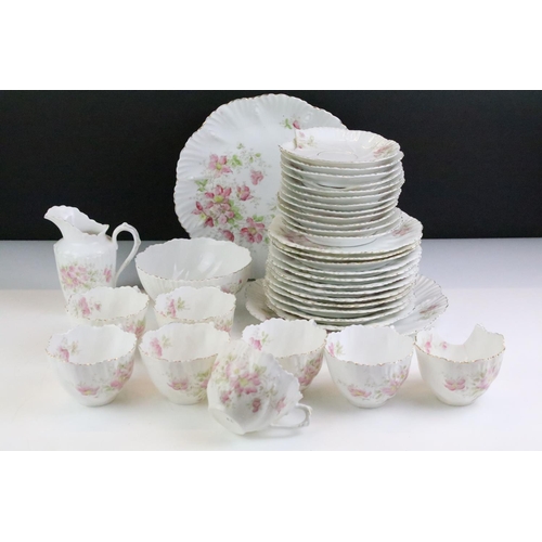 148 - Early 20th Century tea service having a white ground with pink floral sprays and gilt rims. Marked 4... 