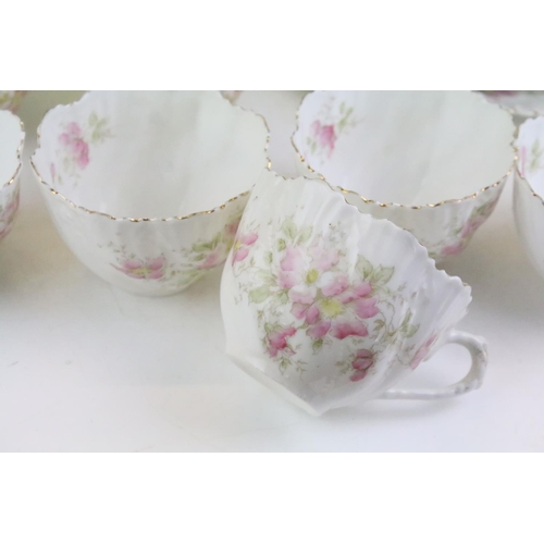 148 - Early 20th Century tea service having a white ground with pink floral sprays and gilt rims. Marked 4... 