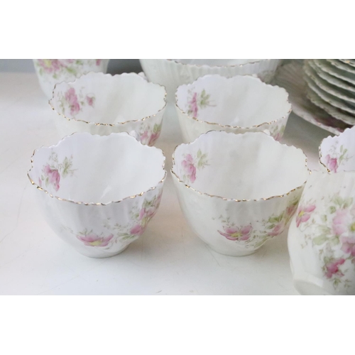 148 - Early 20th Century tea service having a white ground with pink floral sprays and gilt rims. Marked 4... 