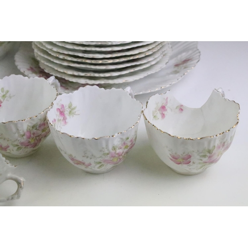 148 - Early 20th Century tea service having a white ground with pink floral sprays and gilt rims. Marked 4... 