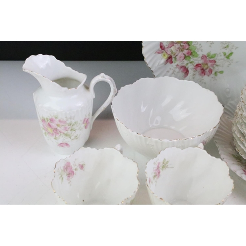 148 - Early 20th Century tea service having a white ground with pink floral sprays and gilt rims. Marked 4... 