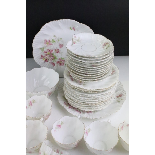 148 - Early 20th Century tea service having a white ground with pink floral sprays and gilt rims. Marked 4... 