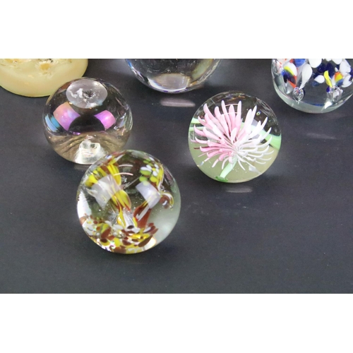 151 - Collection of 20th century paperweights of varying size & colour, featuring floral examples