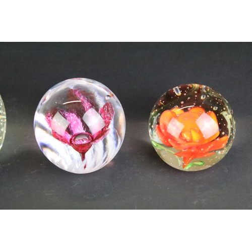 151 - Collection of 20th century paperweights of varying size & colour, featuring floral examples