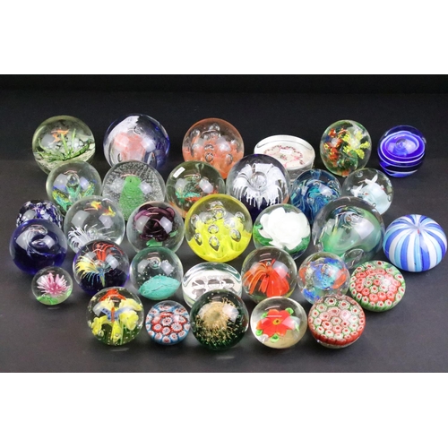 153 - 32 Glass paperweights, some with butterflies, swans, various colours & sizes