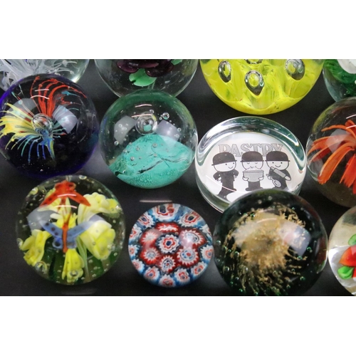 153 - 32 Glass paperweights, some with butterflies, swans, various colours & sizes