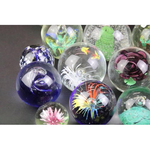 153 - 32 Glass paperweights, some with butterflies, swans, various colours & sizes