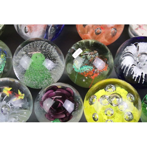 153 - 32 Glass paperweights, some with butterflies, swans, various colours & sizes