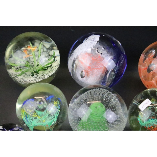 153 - 32 Glass paperweights, some with butterflies, swans, various colours & sizes