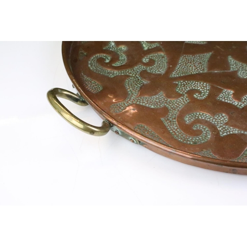 186 - Early 20th Century hammered copper tray having stylised hammered detailing to tray and twin brass ha... 