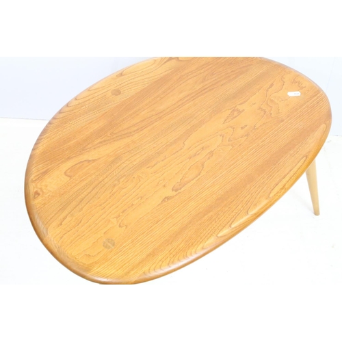 705 - Ercol elm pebble nest of tables each having oval tops raised on tapering turned legs. Ercol sticker ... 