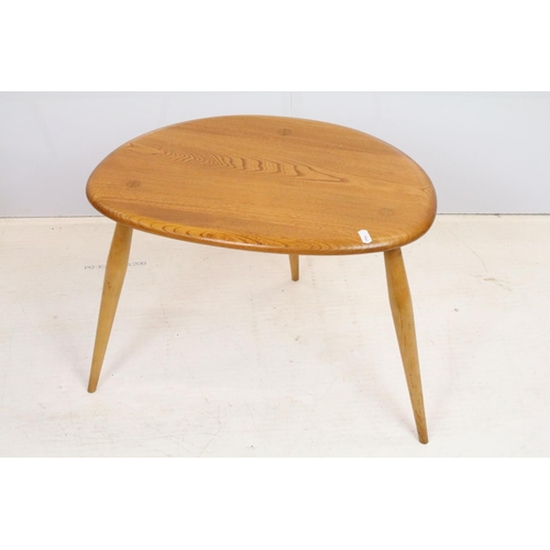 705 - Ercol elm pebble nest of tables each having oval tops raised on tapering turned legs. Ercol sticker ... 