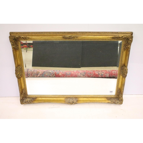 698 - Large gilt framed bevelled edged rectangular wall mirror with scroll detail, approx 104cm W x 75cm H