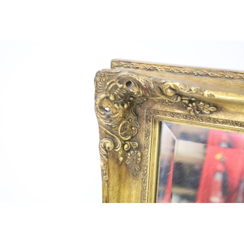 698 - Large gilt framed bevelled edged rectangular wall mirror with scroll detail, approx 104cm W x 75cm H