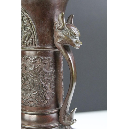 212 - Pair of Chinese Bronze Vases, the twin handles in the form of mythical beast heads, 24cm high