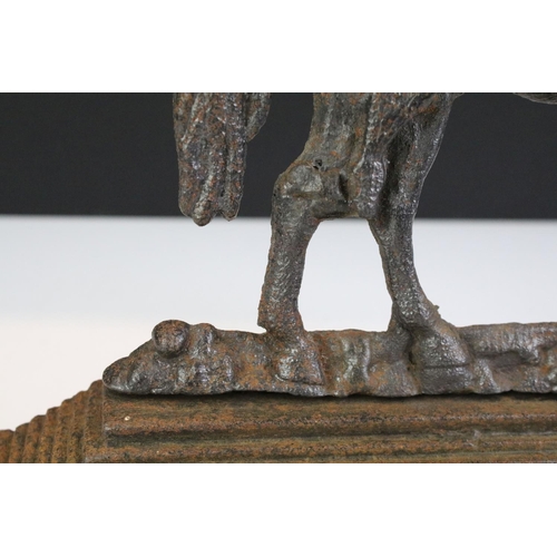 213 - 19th Century Victorian cast iron door stop in the form of a Boer War horse raised on a stepped base.... 