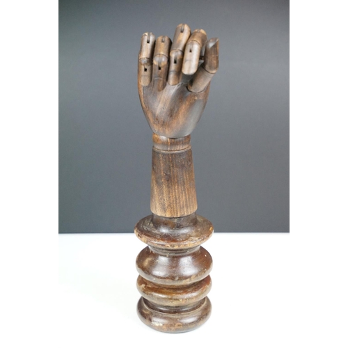 168 - Artist model hand with articulated fingers, raised on a turned wooden base, approx 44cm high