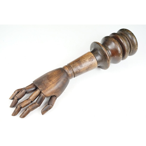 168 - Artist model hand with articulated fingers, raised on a turned wooden base, approx 44cm high