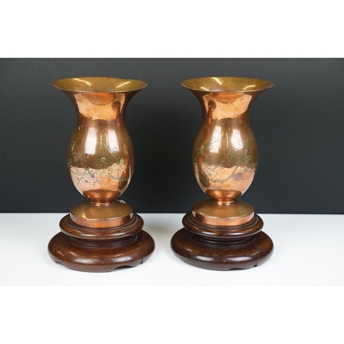 169 - Pair of Chinese Bronze Vases with prunus blossom engraving, raised on wooden stands, 22cm high