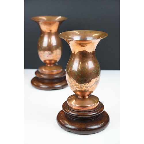 169 - Pair of Chinese Bronze Vases with prunus blossom engraving, raised on wooden stands, 22cm high