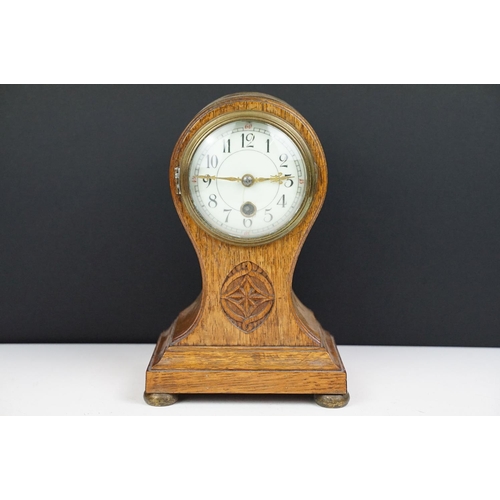 174 - Edwardian balloon oak mantel clock with white enamel dial and carved detail, approx 22.5cm high