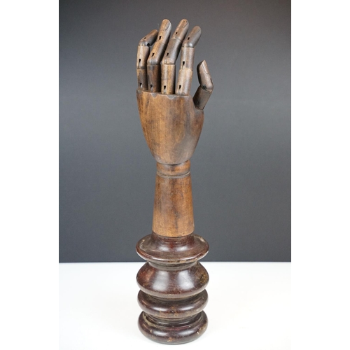 174A - Artist model hand with articulated fingers, raised on a turned wooden base, approx 44cm high