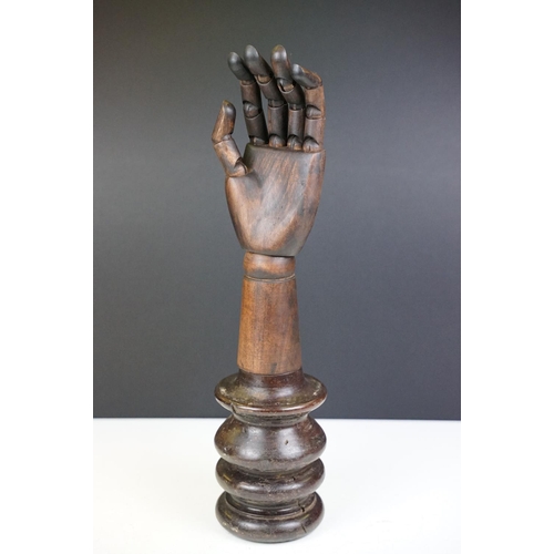 174A - Artist model hand with articulated fingers, raised on a turned wooden base, approx 44cm high